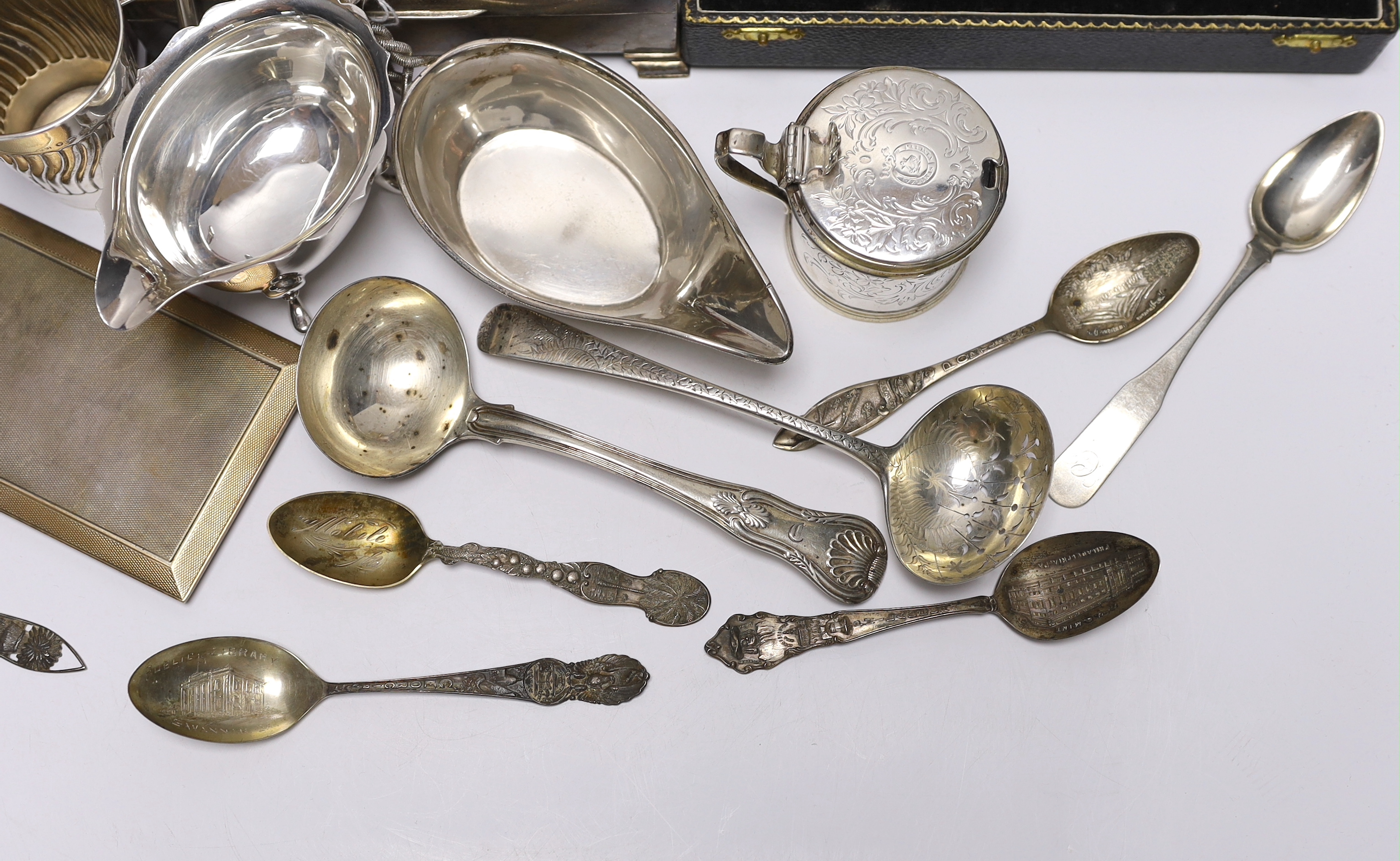 Sundry silver wares including a cigarette box and case, cased condiment set, cased pair of pepperettes and cased set of six teaspoons, sauceboat, Victorian mustard, Victorian mug with angular handle, nine items of flatwa